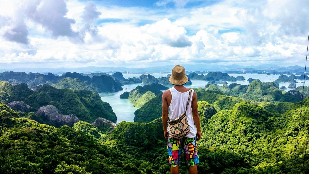 Tourist enjoying the breathtaking view of Ha Long Bay&#39s limestone karsts in Vietnam