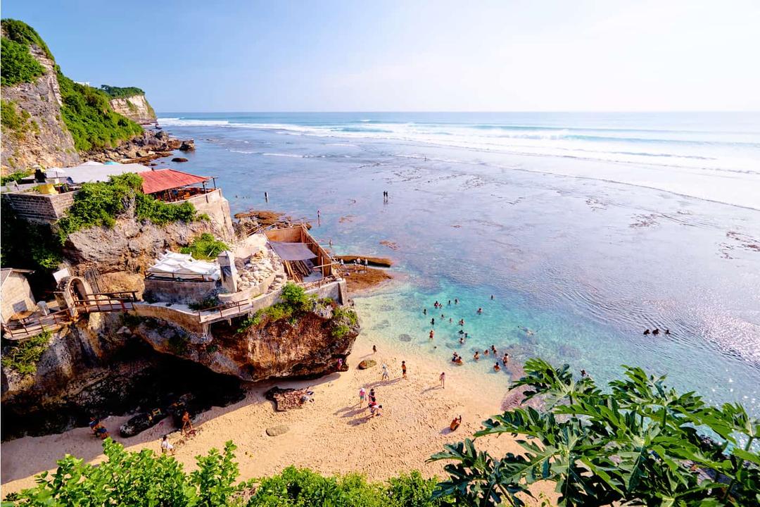 Scenic Uluwatu Beach in Bali, a breathtaking coastal destination frequently explored in Bali Travel packages