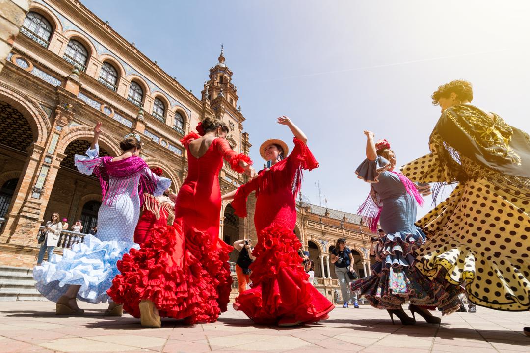 SEVILLE, SPAIN - MAY 2017 Young women dance flamenco on Plaza de Espana